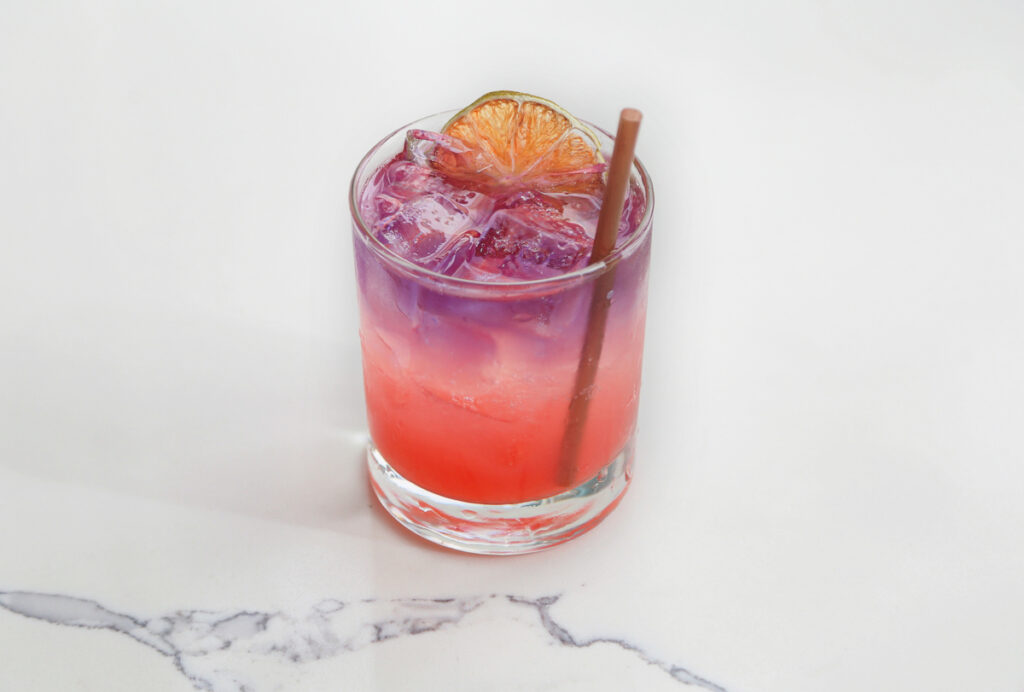 cocktail in focus on marble countertop